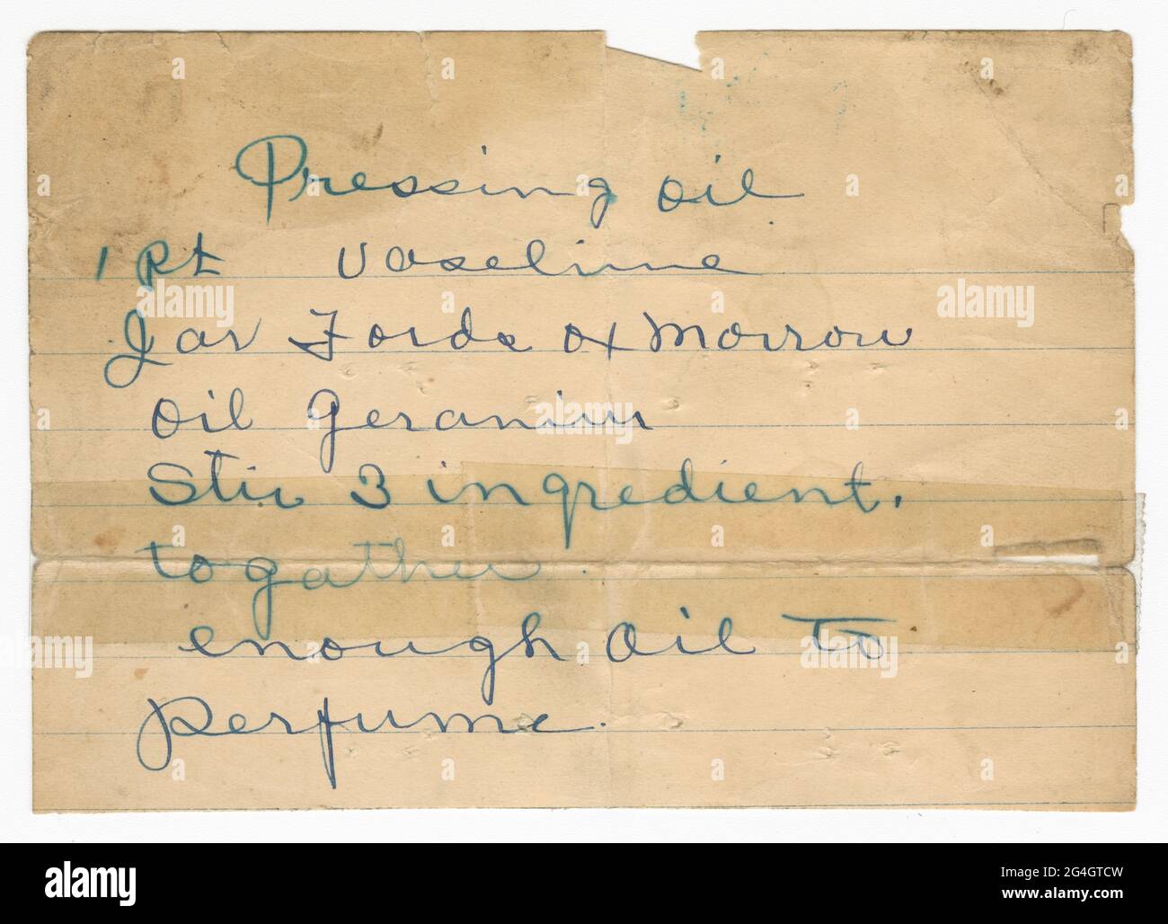 This is a handwritten recipe for Pressing Oil Formula created by Poro College written in blue ink on lined paper. &quot;Pressing oil/ 1 pt vaseline,/Jar Fords ox marrow/ oil geranium/ Stir 3 ingredient,/ together/ enough oil to/ perfume.&quot; The recipe has deep creases from folding that have been reinforced with clear tape. Poro College, a cosmetology school and centre, was established in 1918 by Annie Turnbo Malone, an African-American businesswoman, inventor and philanthropist. Stock Photo