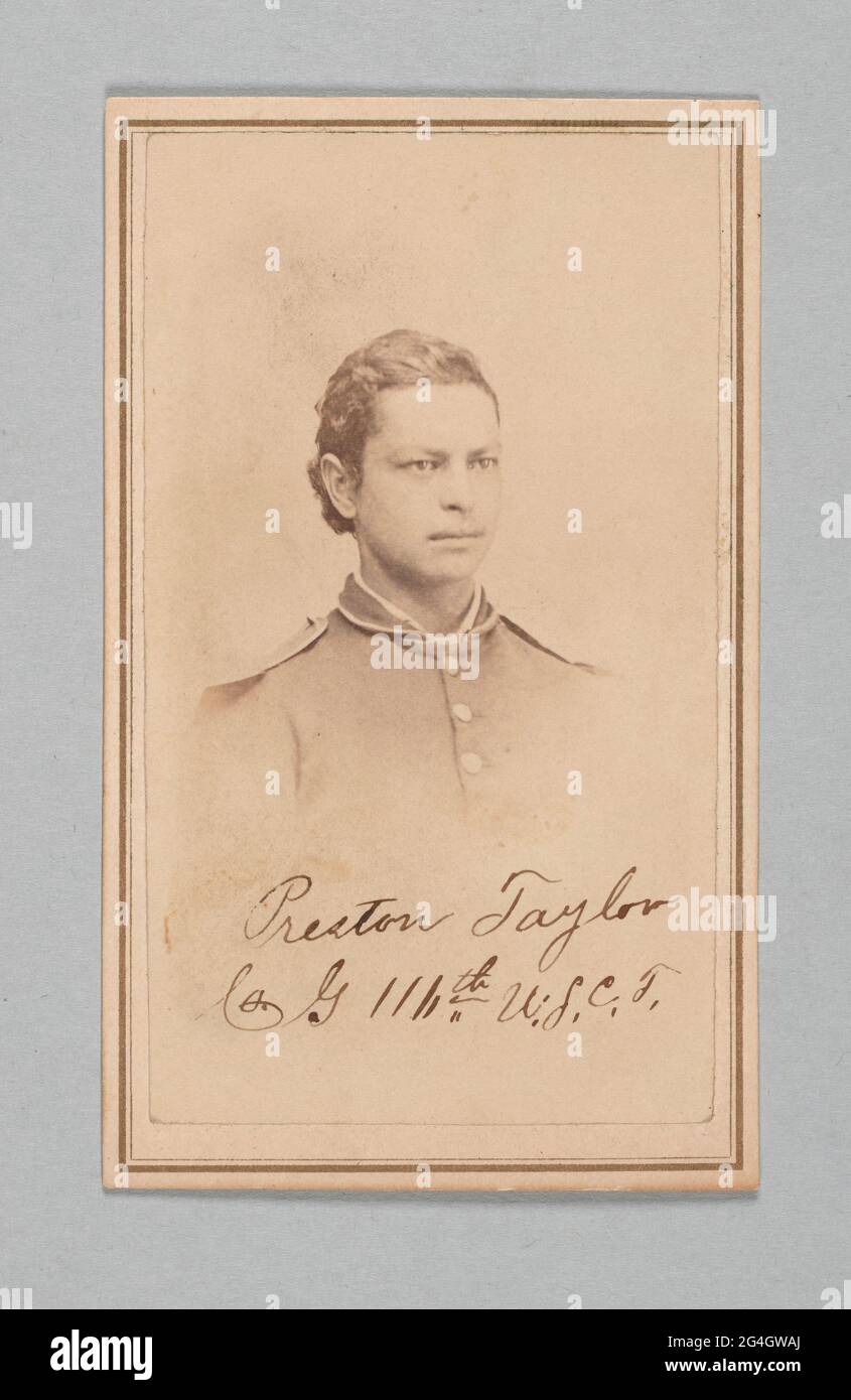 An albumen carte-de-visite photograph, signed, of Preston Taylor, a drummer in the 116th United States Colored Troops. A dark haired young man, Preston Taylor, wears a soldier&#x2019;s uniform jacket with three large buttons vertically attached, white detailing around his collar. Within the fading of Taylor&#x2019;s image, below his jacket buttons, is his signature which reads: [Preston Taylor, Co. G, 116th U.S.C.T.]. The back of the albumen photograph has light stains at the top, and bears the ink printed name and address of the photographer: [L. I. PRINCE, / Photographer / 112 Caral and 8 St Stock Photo