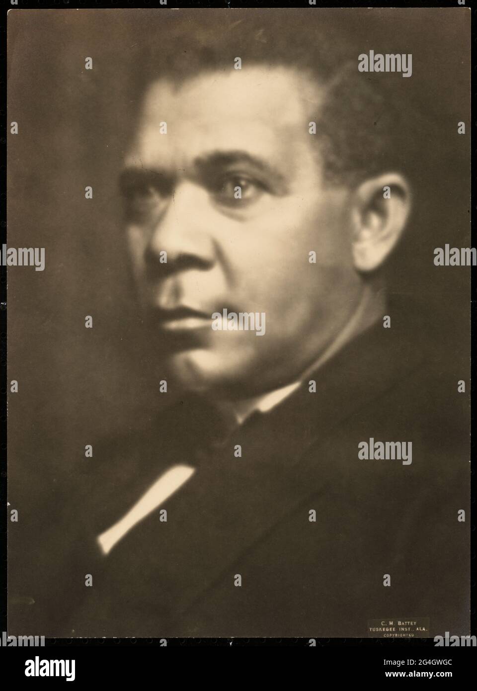 A black-and-white print of a bust-length portrait of Booker T. Washington, seated left. Born into slavery in Virginia, Booker Taliaferro Washington (1856-1915) was an African-American educator, author, orator, and adviser to several presidents of the United States. Stock Photo