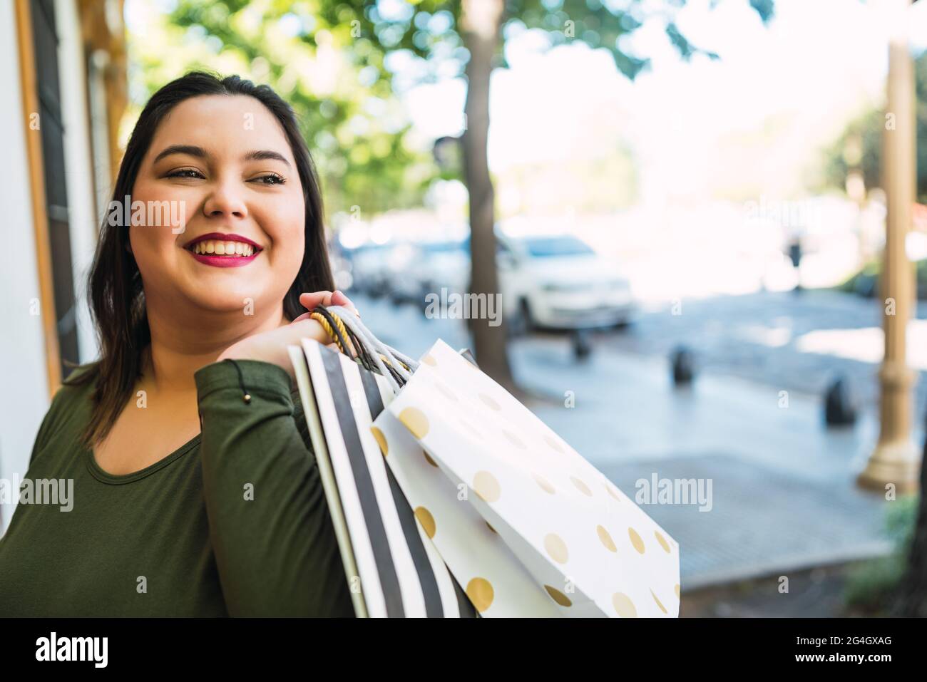Young woman holding shopping bags Stock Photo - Alamy