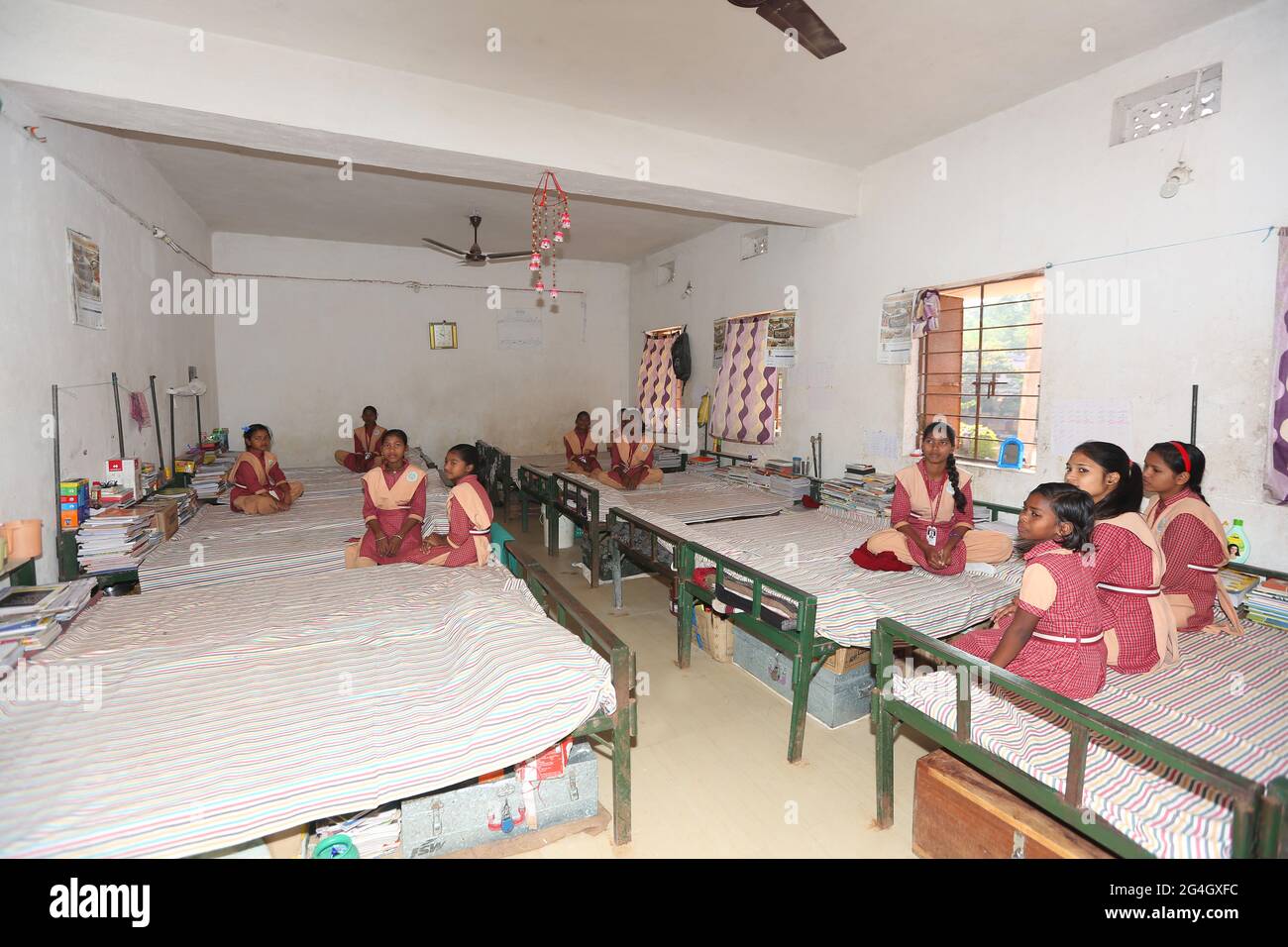 LANJIA SAORA TRIBE. Interior of girls hostel dormitory room serves both as studying and sleeping area. Puttasingh village in Odisha, India Stock Photo