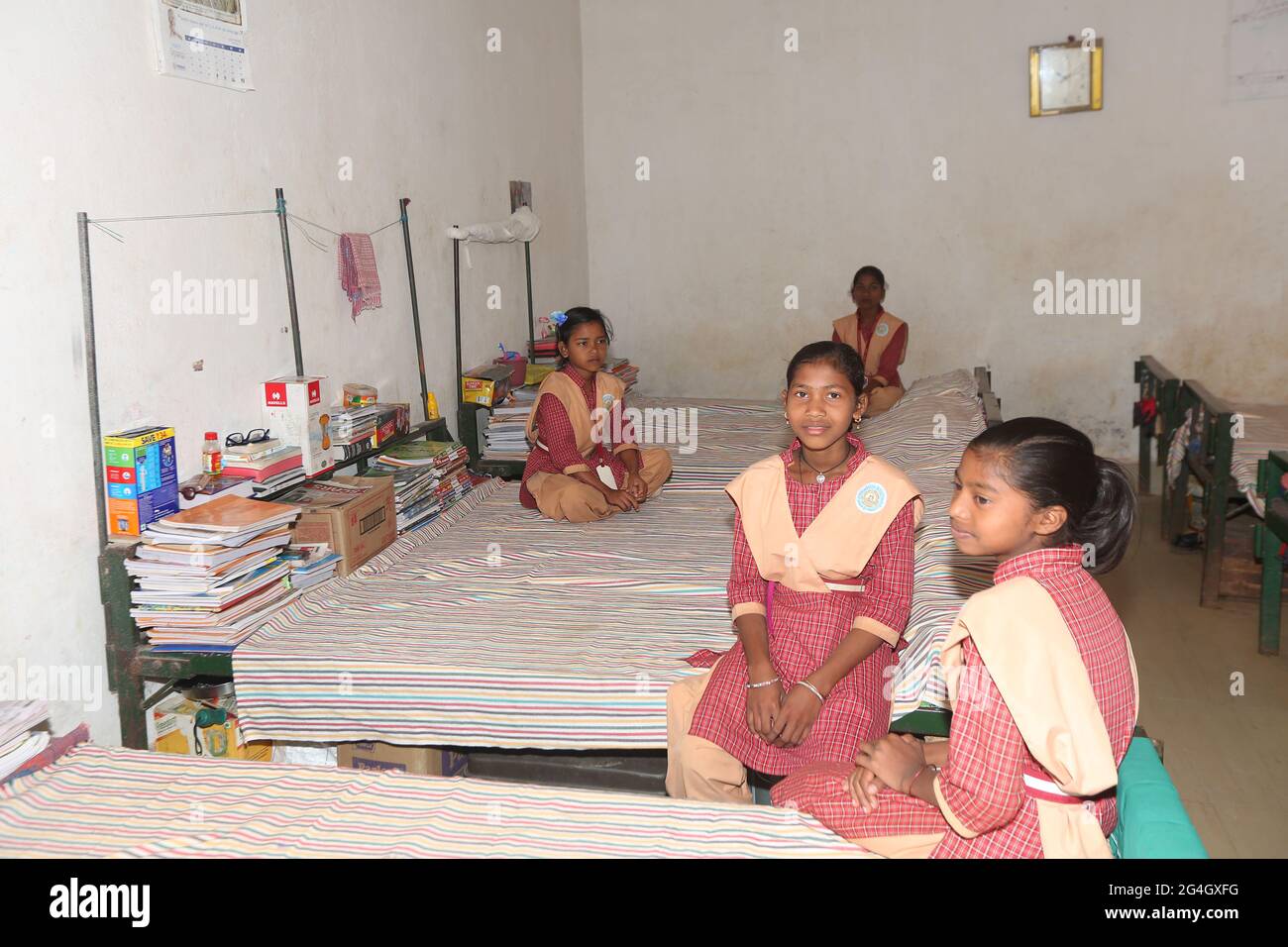 LANJIA SAORA TRIBE. Interior of girls hostel dormitory room serves both as studying and sleeping area. Puttasingh village in Odisha, India Stock Photo