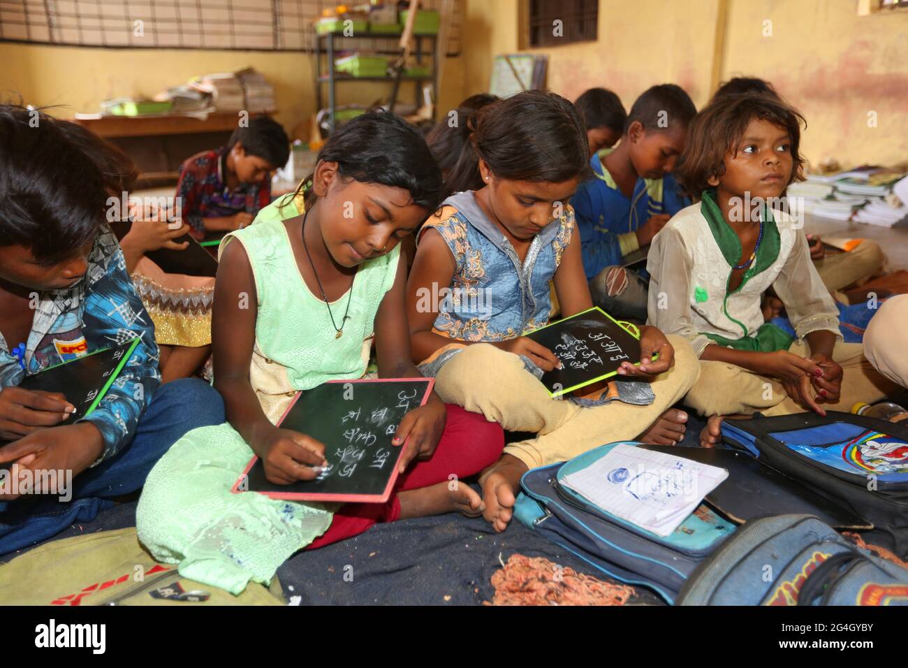 KOL TRIBE. Ashram School students busy in their studies in a classroom. Bhanpur Village of Huzur Tehsil in Rewa Dist, Madhya Pradesh, India Stock Photo