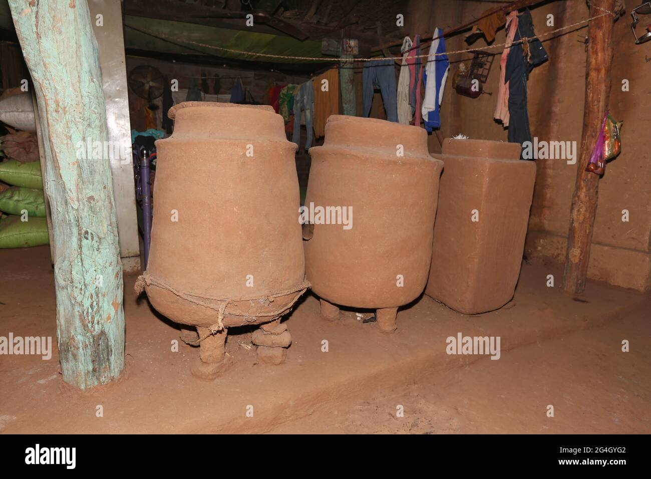 DHANKA TADVI TRIBE. Big handmade mud grain storage vessels placed