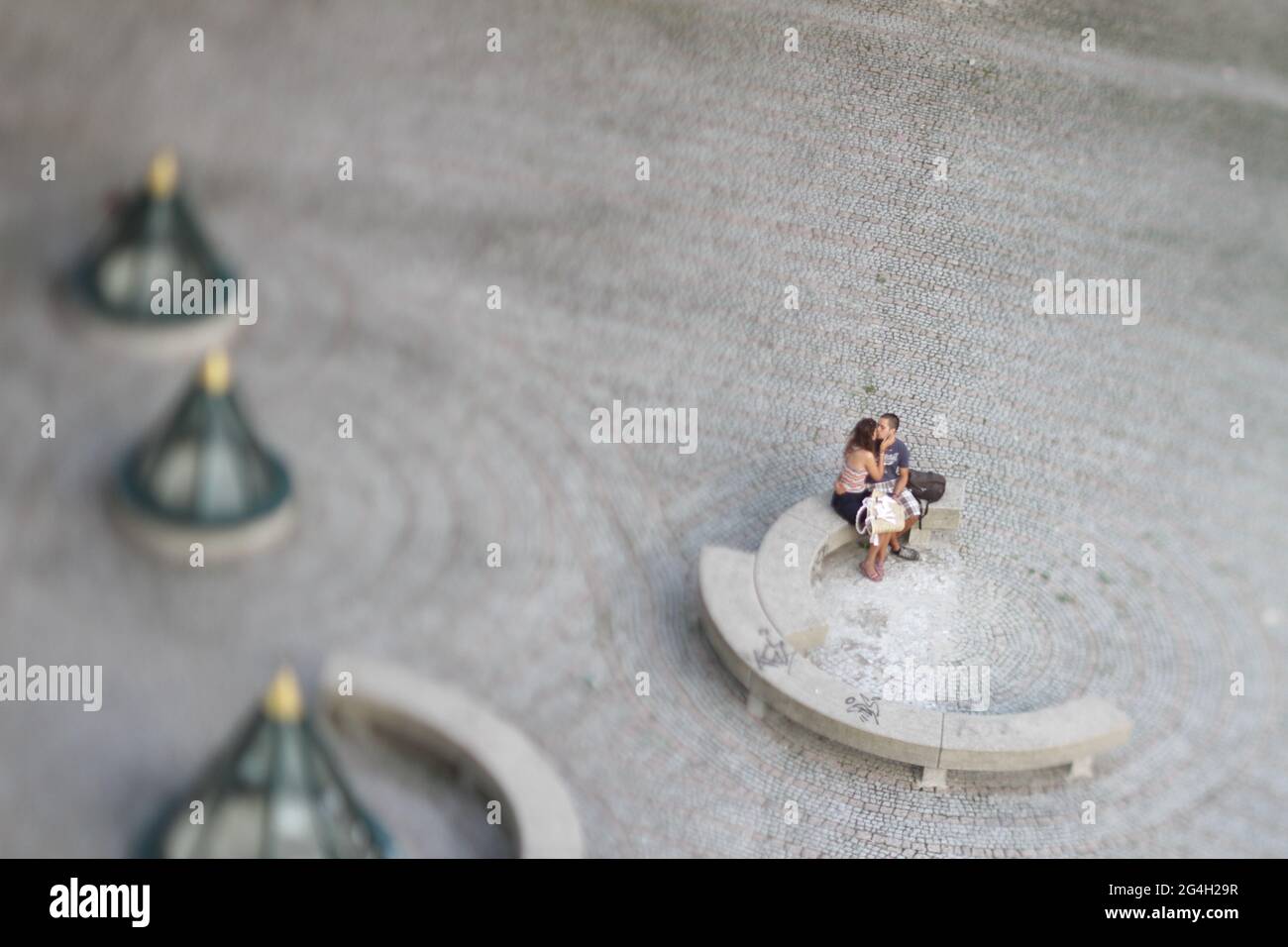 Couple kissing shot with tilt and shift lense making the people