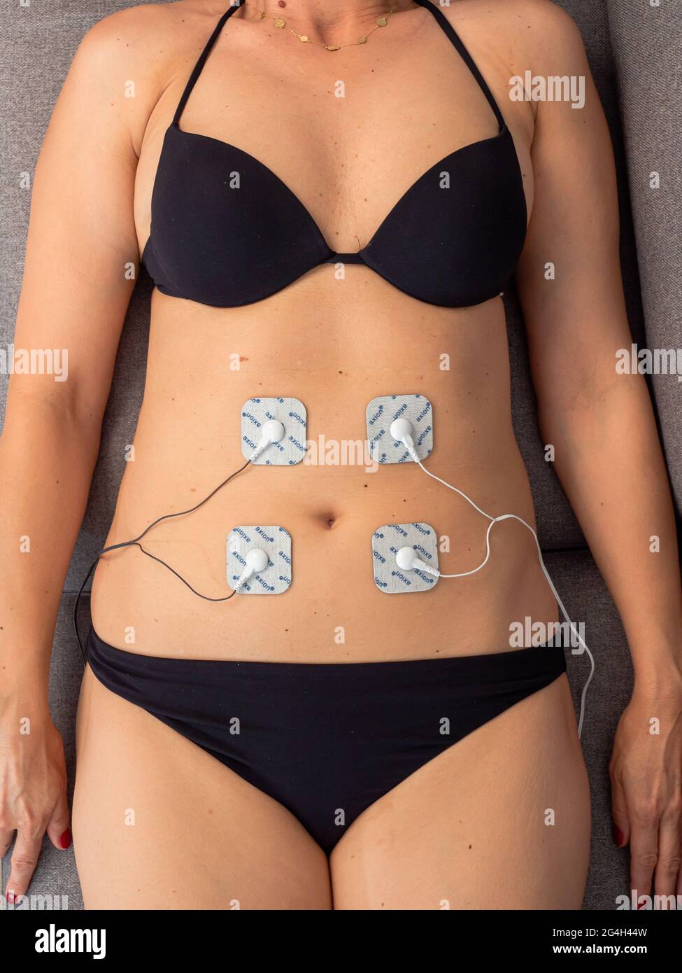 Muscle stimulator with electrodes, the massager on the buttocks and legs.  Rehabilitation and treatment, weight loss and Stock Photo - Alamy