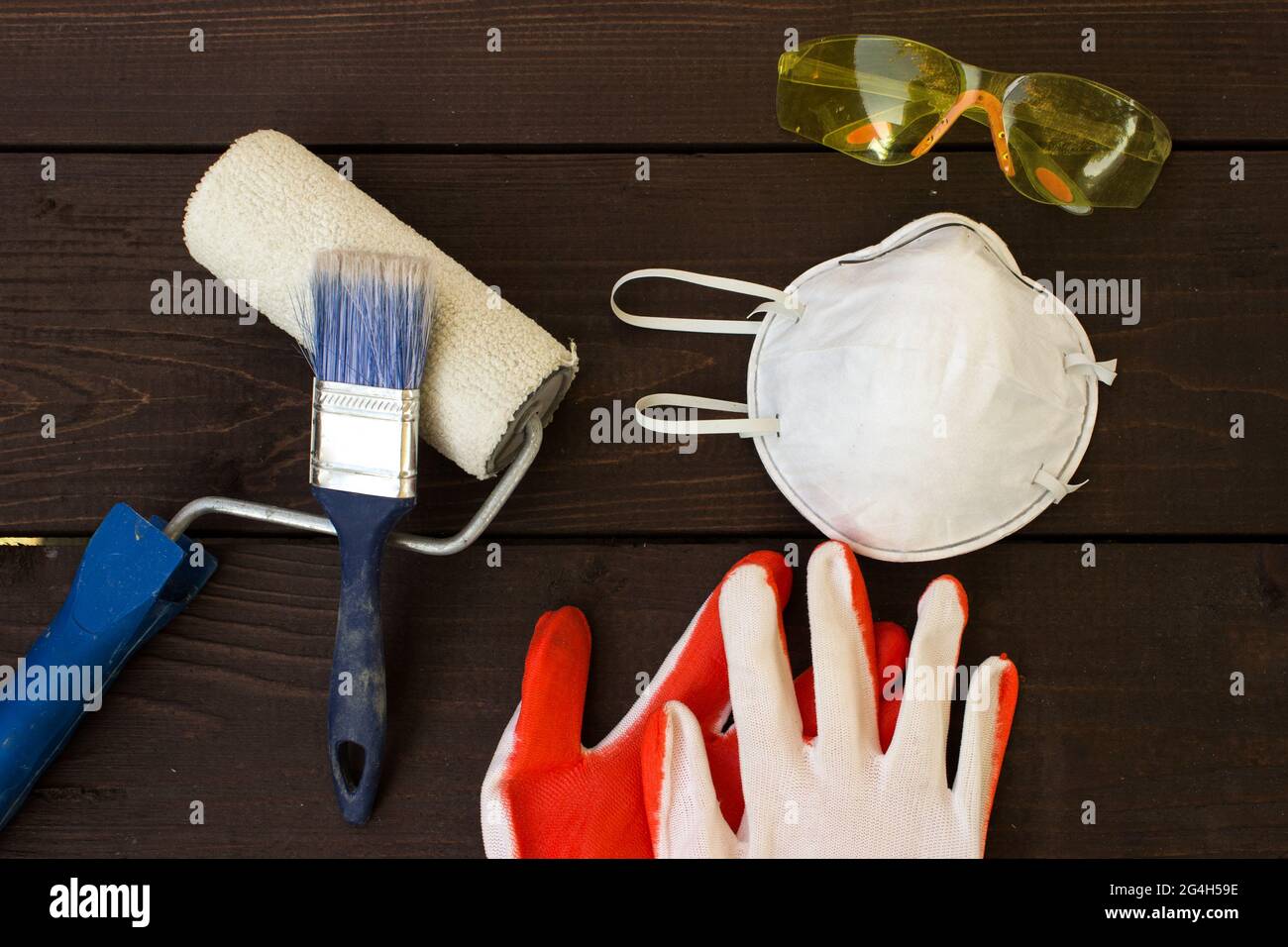 Flat lay composition with safety equipment on wooden background. Industrial protective gear on wooden table. Work safety Stock Photo