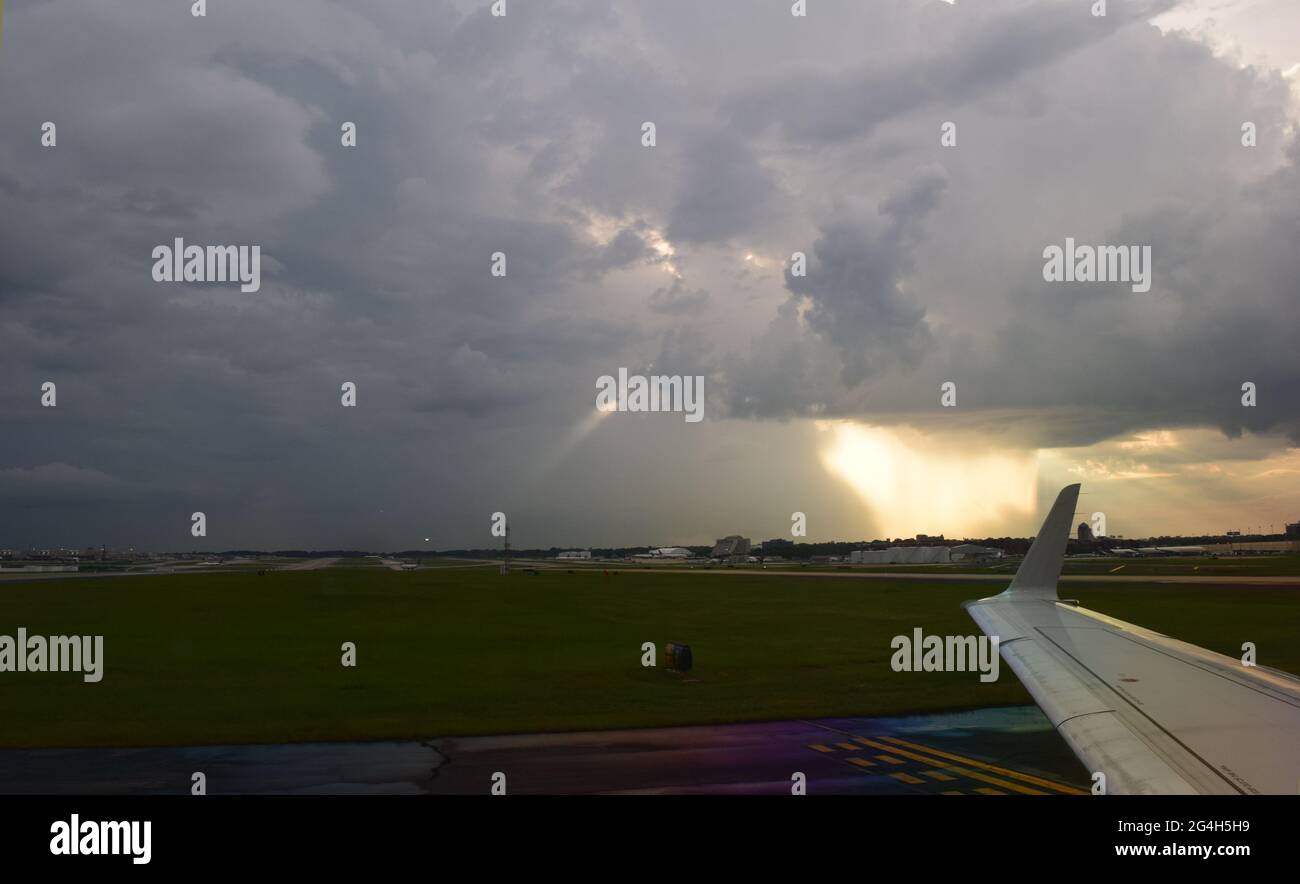 Plane taxiing to terminal at Atlanta airport after landing in heavy rain storm Stock Photo