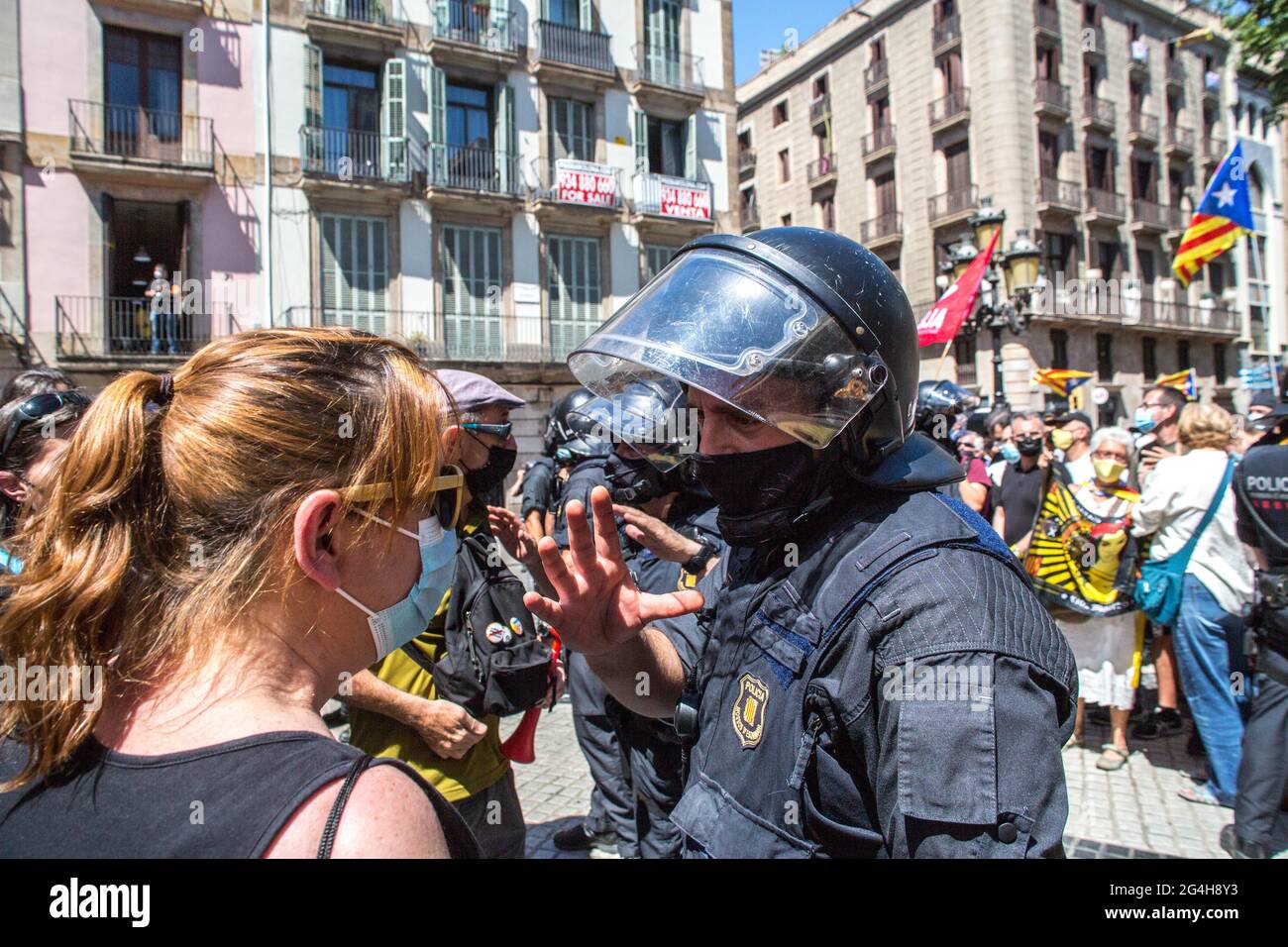A protester seen talking to a police officer during the demonstration.Hundreds of Catalan independentistas have demonstrated in Las Ramblas in Barcelona, in front of the Gran Teatre del Liceu (Great Theater of the Lyceum), shielded by many policemen, to protest the visit of the President of the Spanish Government, Pedro Sanchez, who has held a conference entitled 'Reunion: a project for the future for all of Spain', with the expectation of an imminent granting of pardons for the independence leaders in prison. The protesters protested to denounce that the repression against the Catalan indepen Stock Photo
