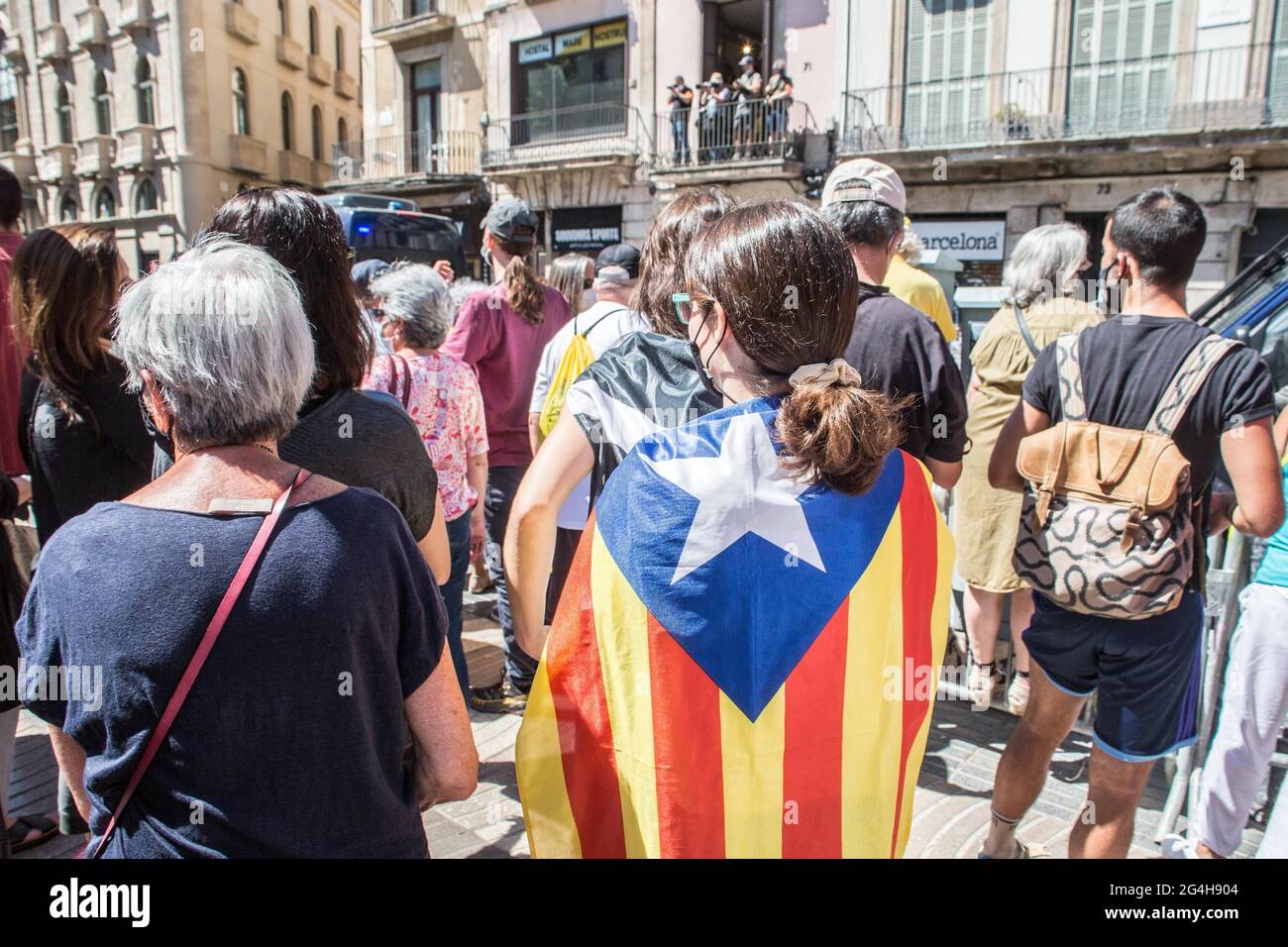 A protester seen with a Catalan independence flag during the demonstration.Hundreds of Catalan independentistas have demonstrated in Las Ramblas in Barcelona, in front of the Gran Teatre del Liceu (Great Theater of the Lyceum), shielded by many policemen, to protest the visit of the President of the Spanish Government, Pedro Sanchez, who has held a conference entitled 'Reunion: a project for the future for all of Spain', with the expectation of an imminent granting of pardons for the independence leaders in prison. The protesters protested to denounce that the repression against the Catalan in Stock Photo