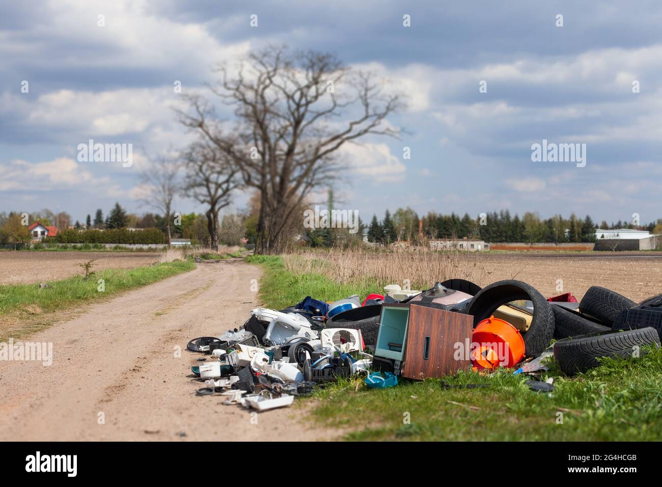 LESZNO, POLAND May 03, 2021 Illegal garbage dump among fields, by the road. Waste electronics