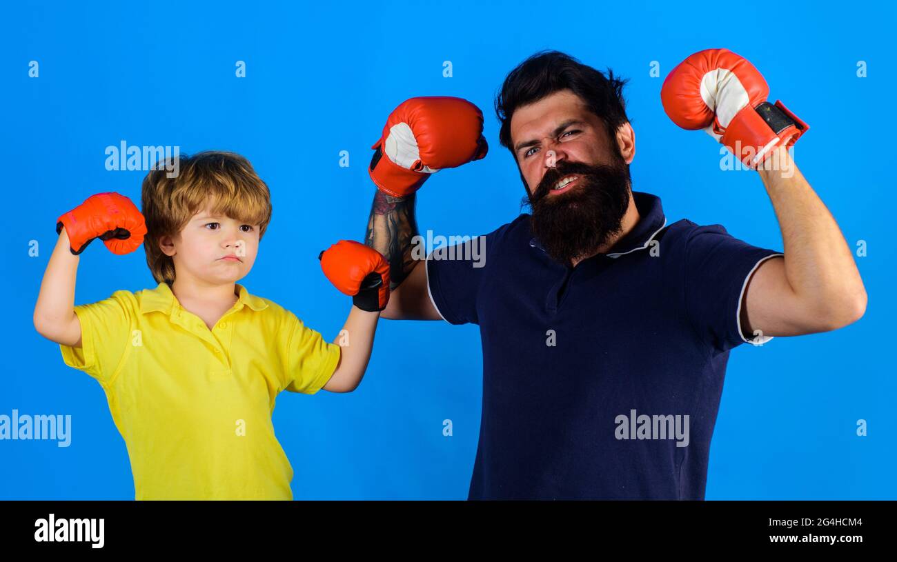Little boy sportsman at boxing training with coach. Child boy doing