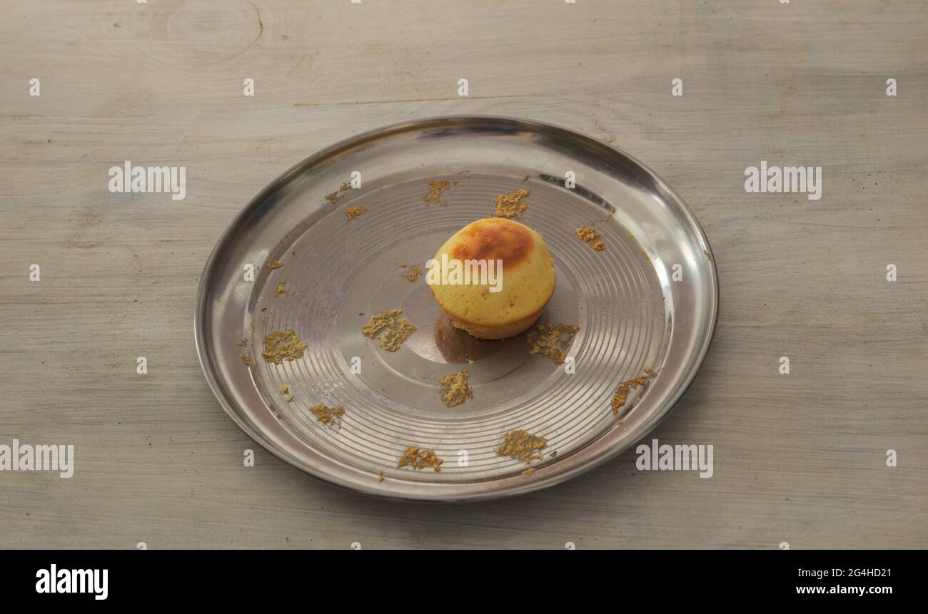 One last cupcake on a metal plate Stock Photo