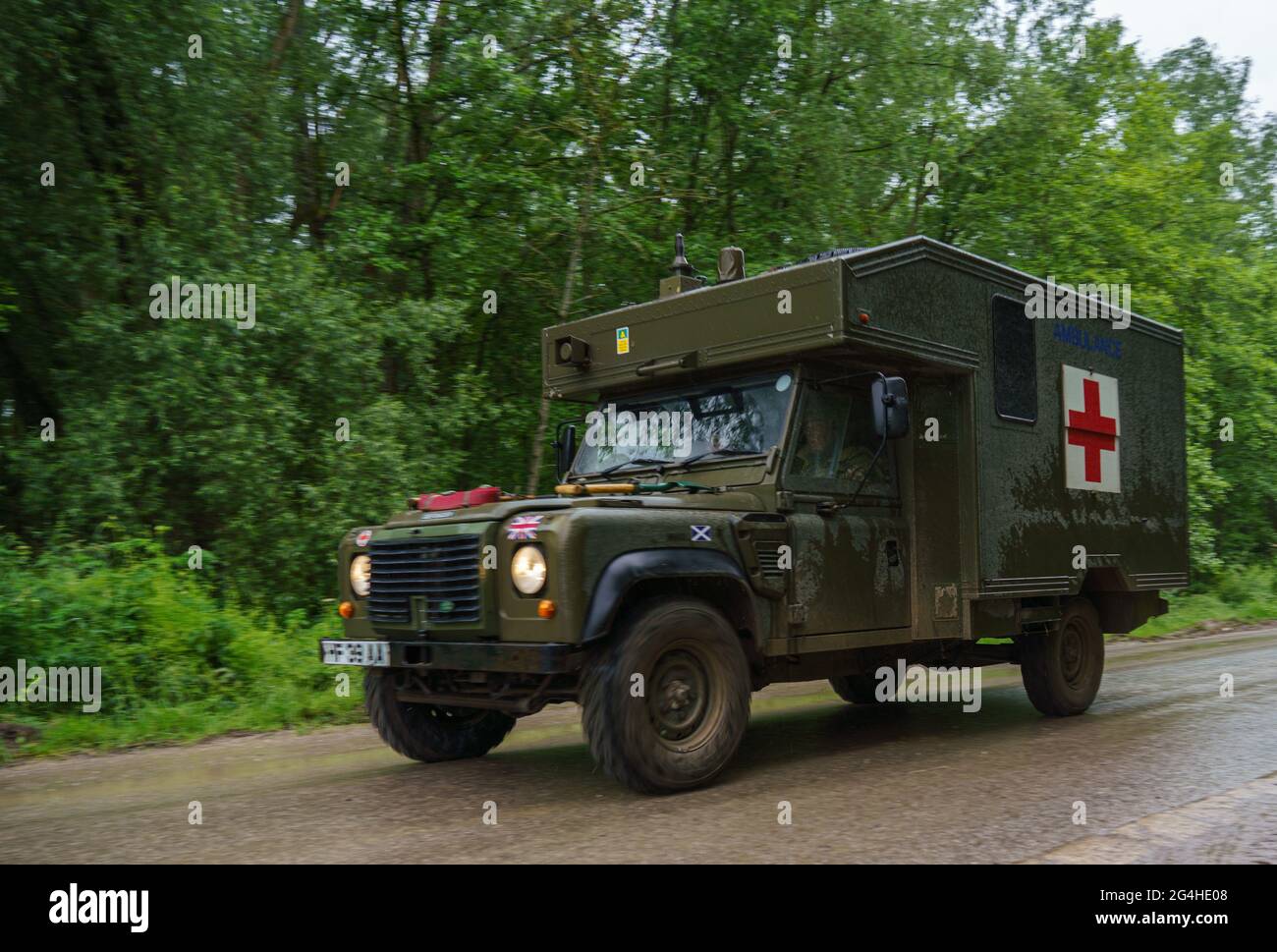 a British army Defender 130 Battle Field Ambulance in action on a military exercise, Wiltshire UK Stock Photo