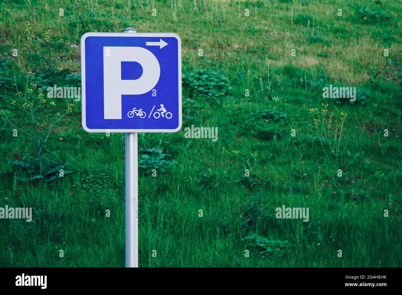 Parking sign for cyclists on the background of green grass Stock Photo