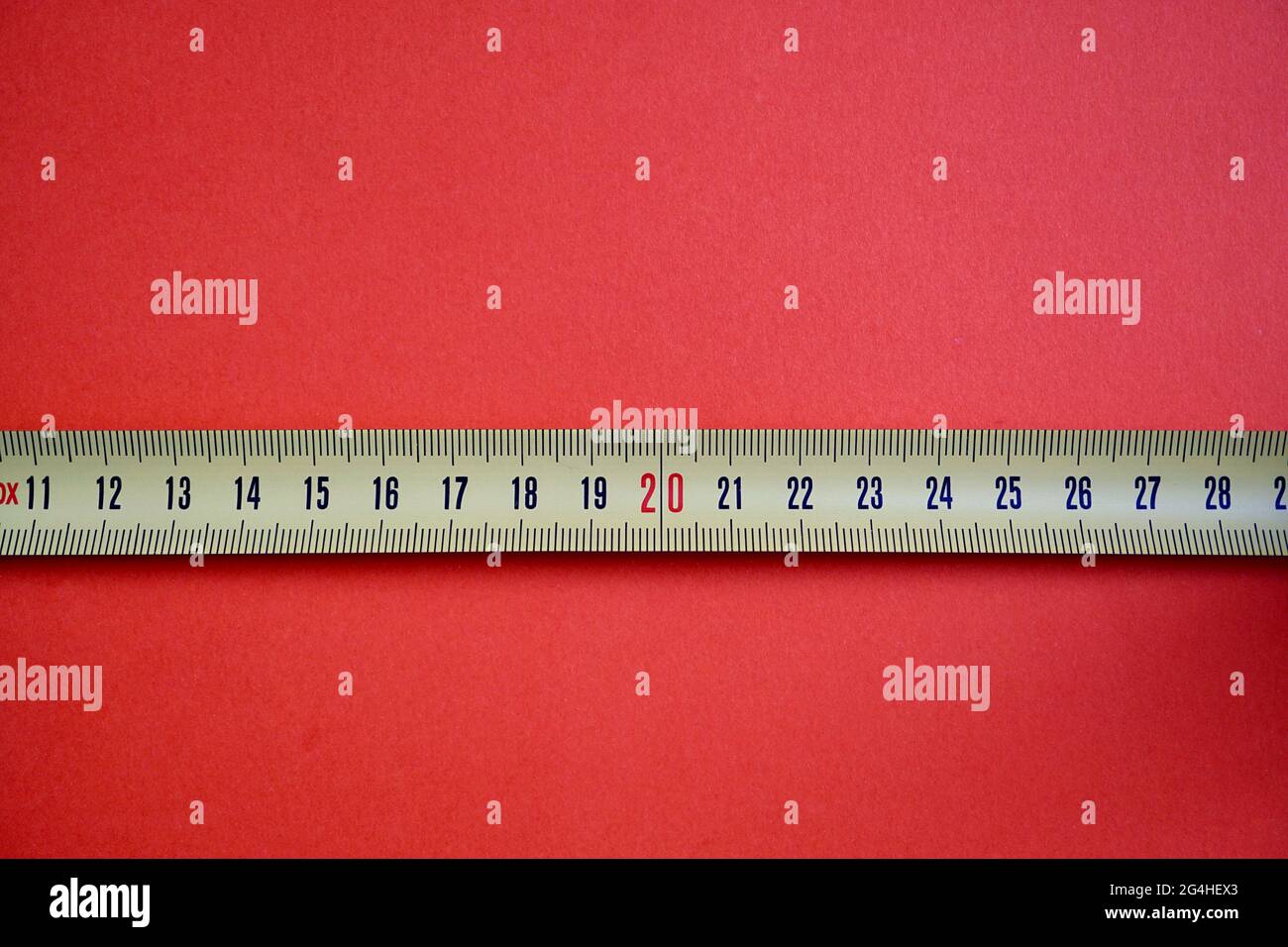 Tape measure isolated on a red background Stock Photo