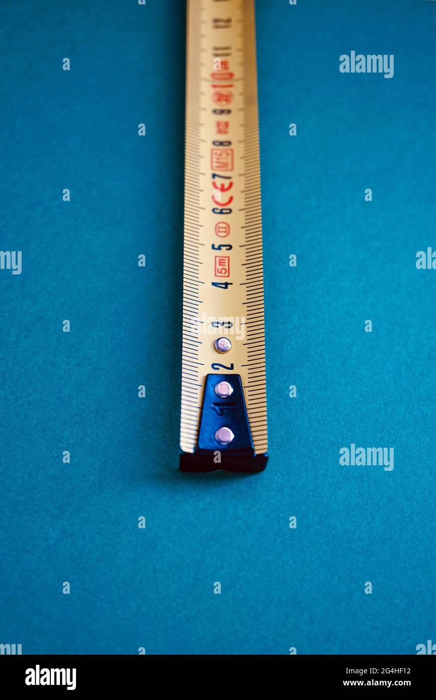 Tape measure isolated on a blue background Stock Photo