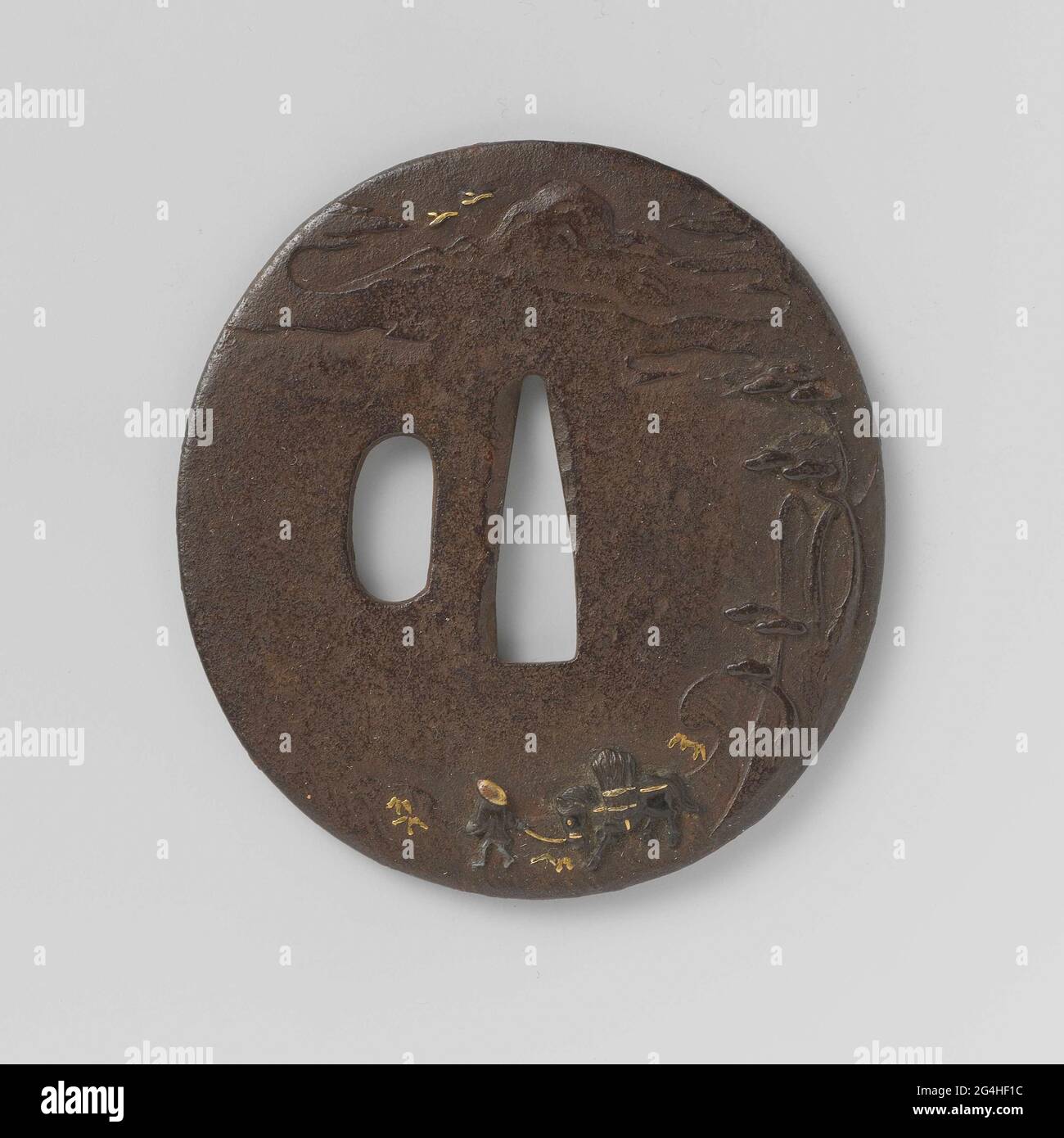 . Oval tsuba with a man with a horse with branches or straw bosses in a