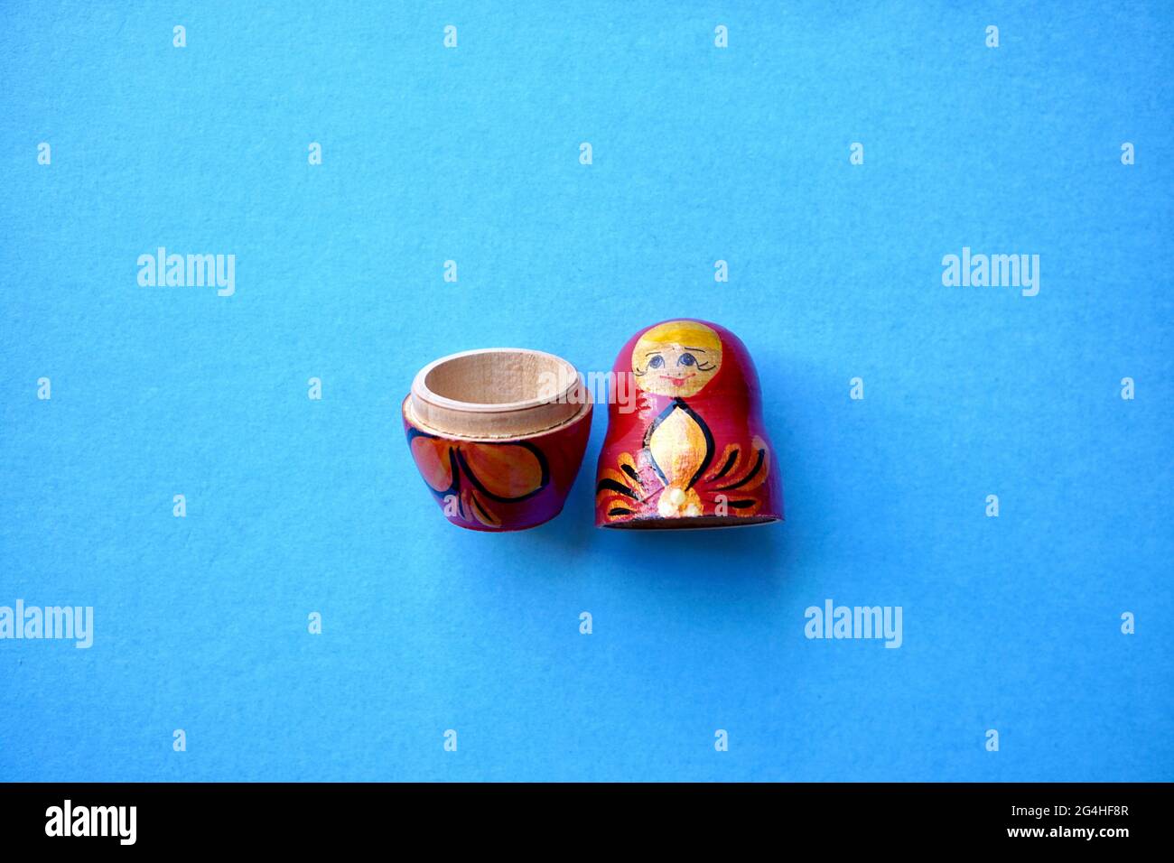 Traditional Russian matryoshka doll isolated on a blue background Stock