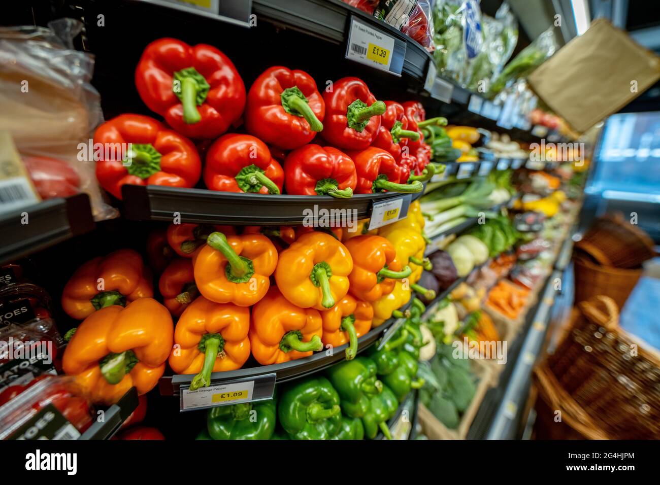 Variety of vegetables on sale at a supermarket. Mainly focussed on peppers here. Stock Photo