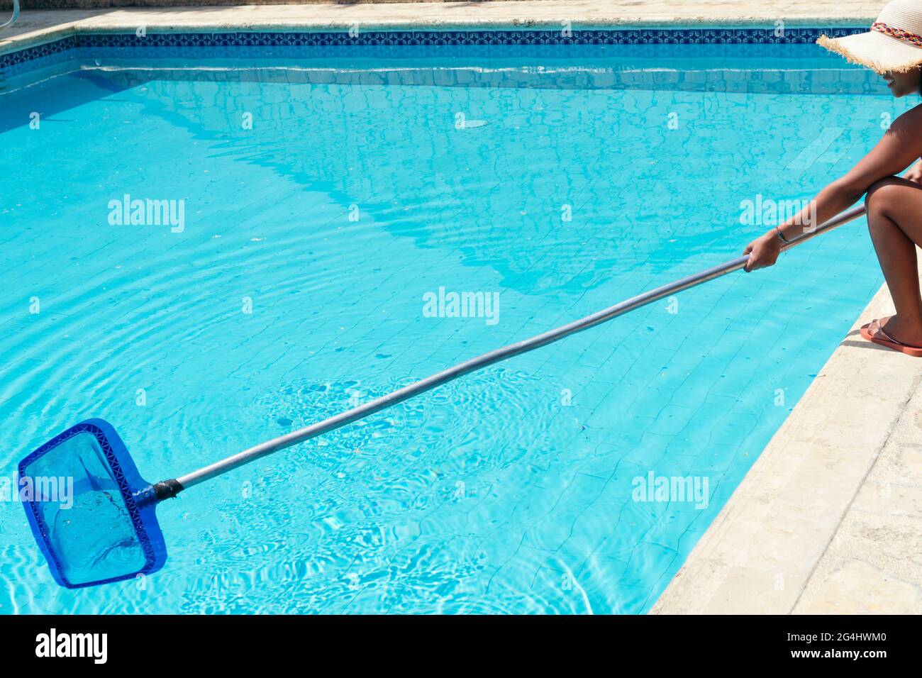 Woman, staff cleaning the pool Stock Photo Alamy