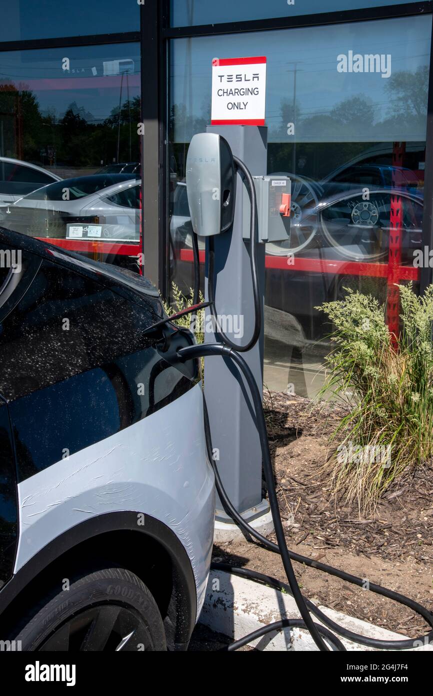 Maplewood, Minnesota. Tesla car dealership. Car at charging stations