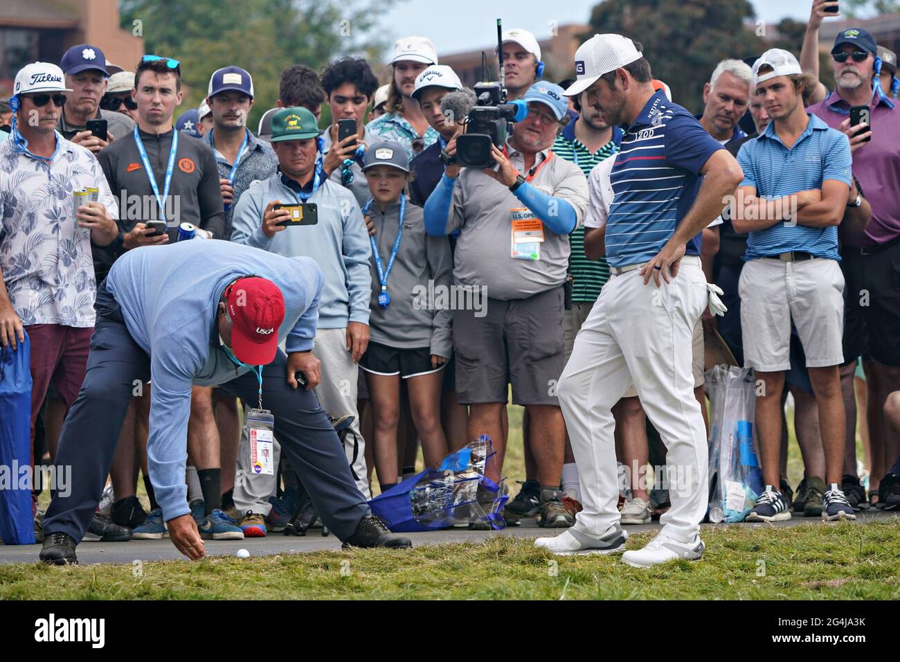 San Diego, United States. 21st June, 2021. Louis Oosthuizen of South Africa, right, watches as a USPGA judge decides the drop of his ball after hitting into the gallery on the 14th fairway in the final round at the 121st US Open Championship at Torrey Pines Golf Course in San Diego, California on Sunday, June 20, 2021. Photo by Richard Ellis/UPI Credit: UPI/Alamy Live News Stock Photo