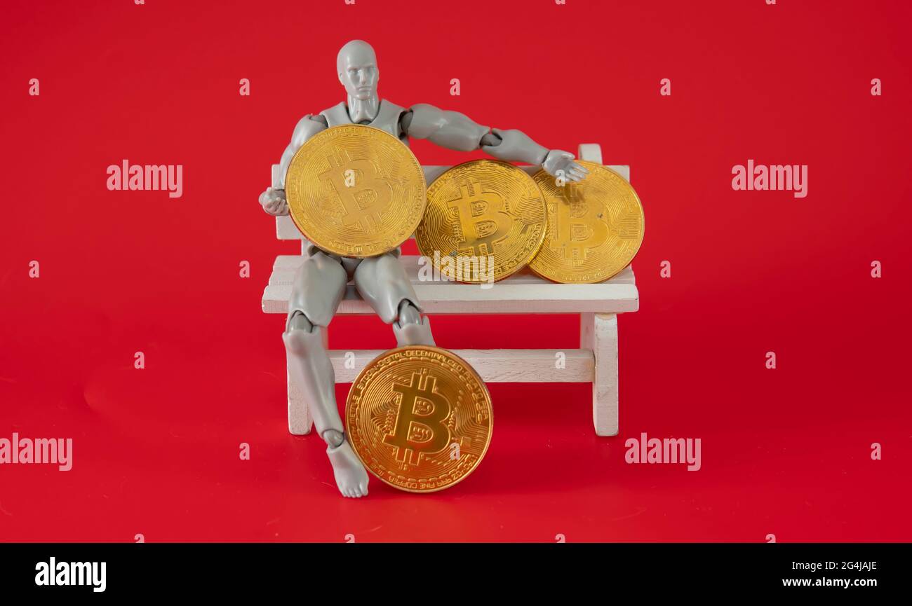 Bitcoin Cryptocurrency. Digital Currency of The Future. Selective focus of  a doll on the knee holding bitcoin replica Stock Photo - Alamy