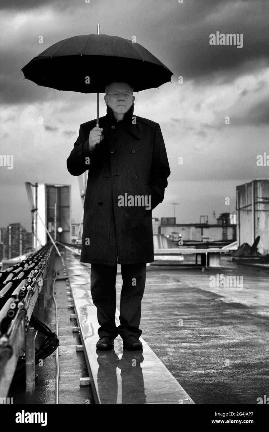 Portrait of Oscar Hahn, Chilean poet with umbrella. Stock Photo