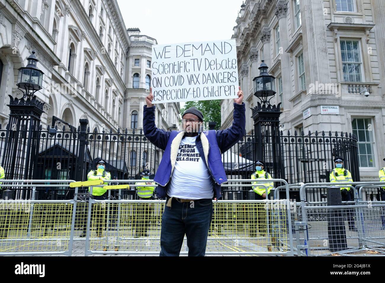 A protester stands with a placard asking for tranparency about the Covid-19 vaccine risks as the roll out will soon extend to children. Stock Photo