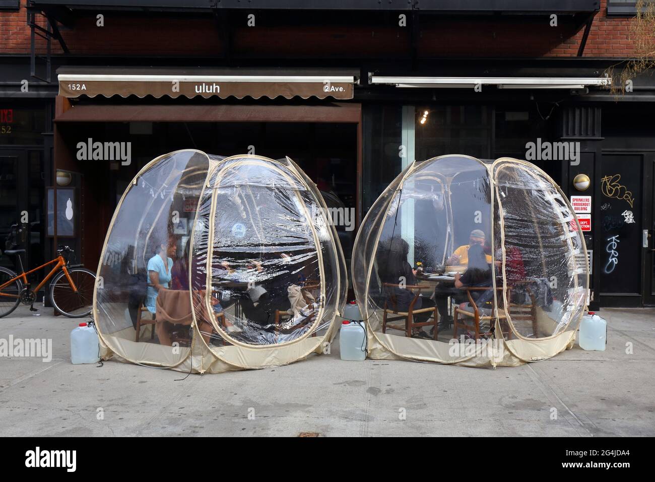 Outdoor dining bubbles at a restaurant in New York, NY. The individual dining enclosures were setup to adhere to NYC dining restrictions during covid Stock Photo