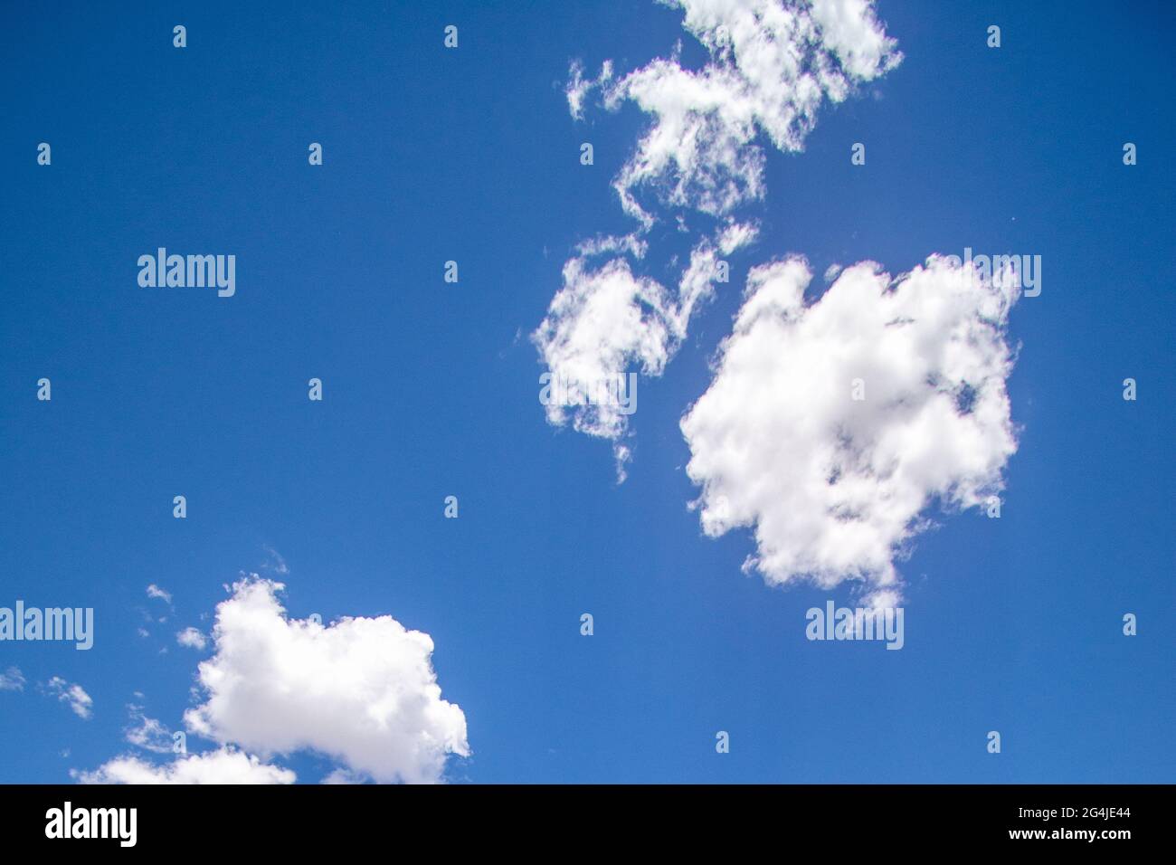 Low angle shot of a blue sky with fluffy clouds - for backgrounds Stock ...