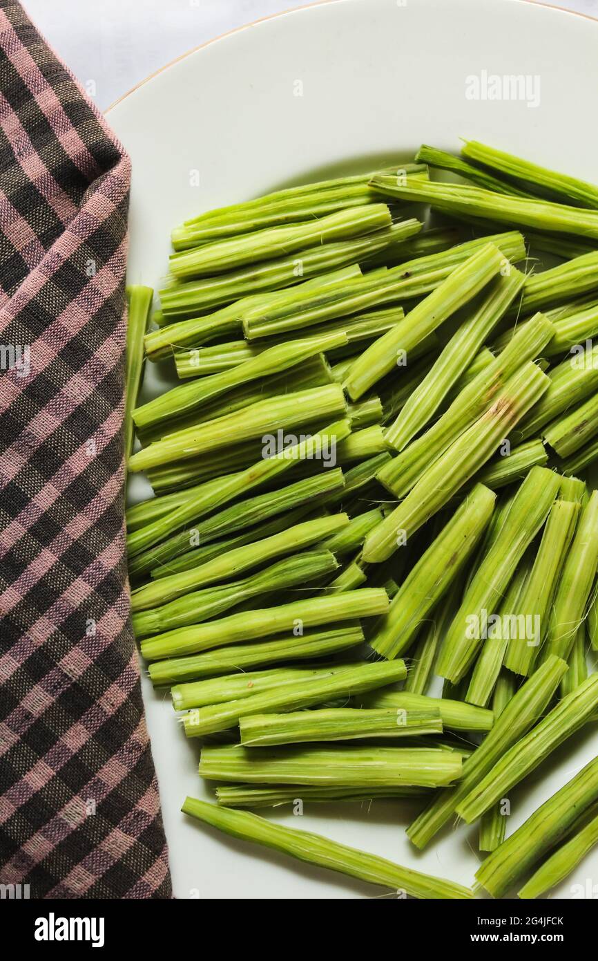 Drumstick vegetable chopped pieces in a bowl along with raw drumstick