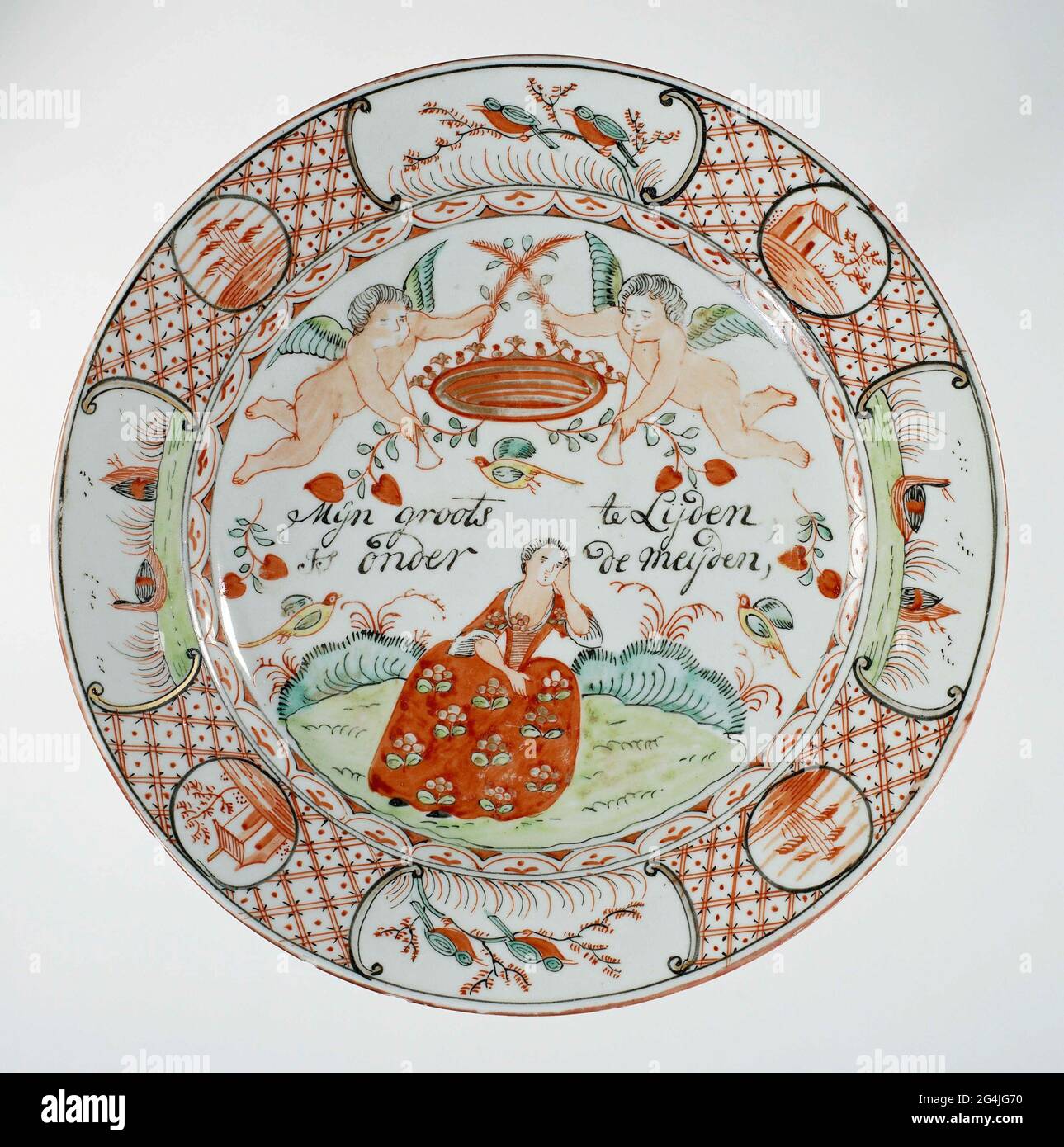 . Porcelain plate, painted on the glaze in red, green, black and gold. On the flat a woman, Princess Anne van Hannover (1709-1759) sitting in a landscape with two flying putti with a crown above her; In between, the inscription 'My grand is suffering from the Meijden'; a decorative band on the wall; The edge with napkin interspersed with four medallions with a landscape and four cartouches with two birds on a branch or two swimming ducks. Two cracks in the edge; Some chips in the edge. Decorated in Europe. Stock Photo