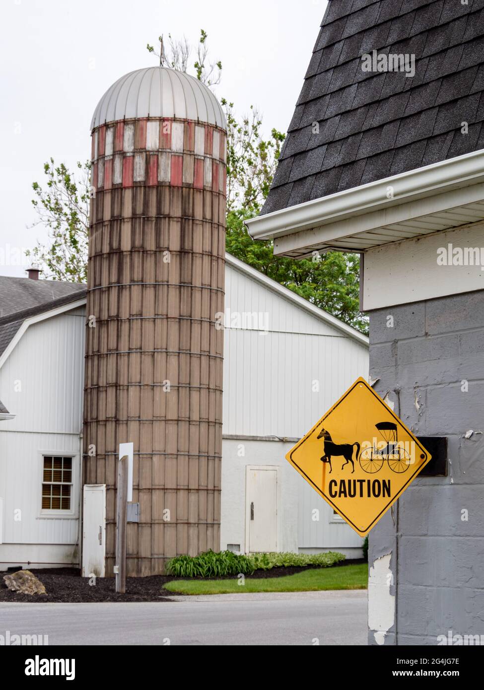 Amish farm with yellow warning buggy road sign Stock Photo