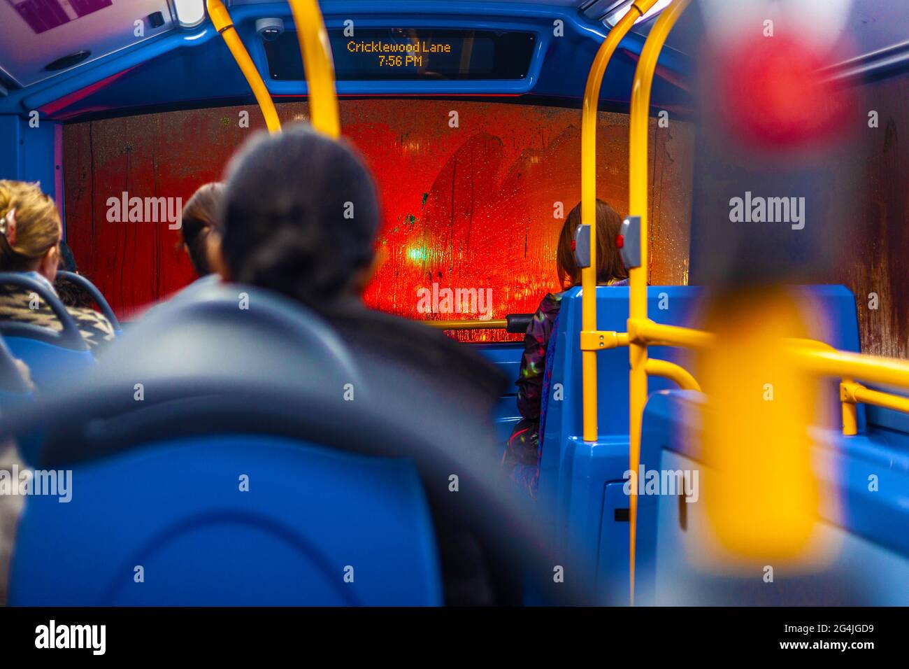 Passengers wait patiently on the upper deck of a bus stuck in traffic, on a rainy evening, London, England, UK. Stock Photo