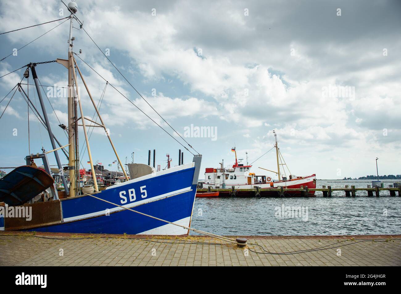 Fehmarn, Germany. 20th June, 2021. Two fishing boats lie in a pier in the Burgstaaken municipal harbour. The harbour basin is to be dredged to a depth of five metres so that the small harbour becomes competitive again. (to dpa 'Fehmarn wants to deepen Burgstaaken municipal harbour') Credit: Gregor Fischer/dpa/Alamy Live News Stock Photo