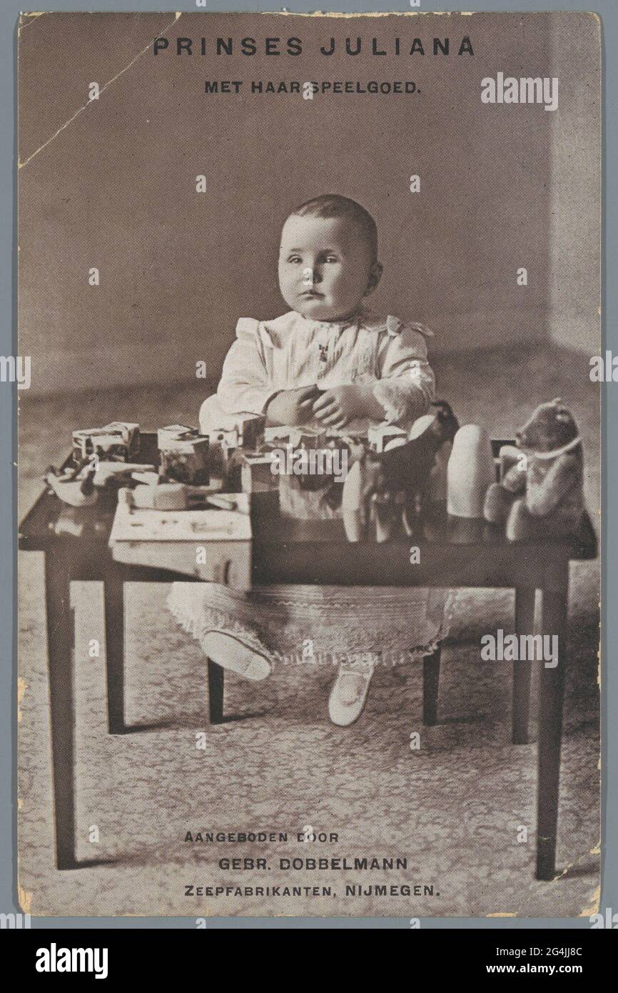 Princess Juliana with her toys. Postcard with portrait of princess juliana sitting in front of a table with toys. Offered by Gebr. Dobbelmann, soap manufacturer, Nijmegen. Stock Photo
