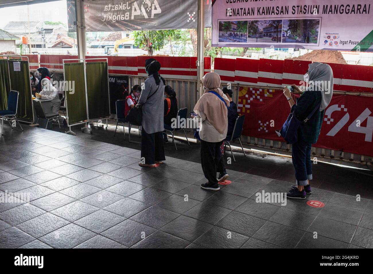 Commuters wait in line for an antigen test at the Manggarai Station in Jakarta. PT KAI Commuter