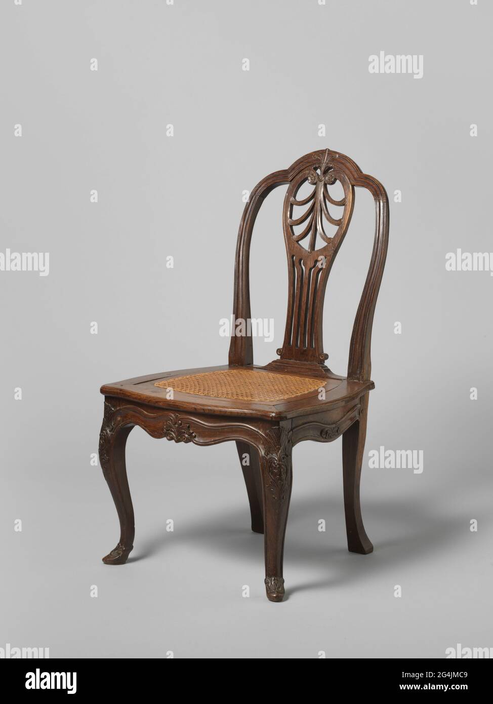 Shell Overhoeks Chair with seat of braided rattan. S-shaped overhoeks placed front legs ...