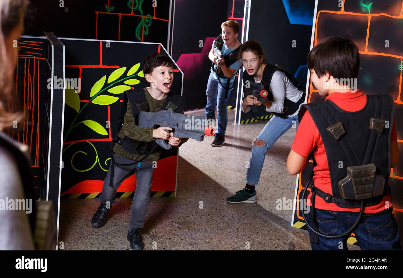 Kids playing laser tag on labyrinth Stock Photo - Alamy