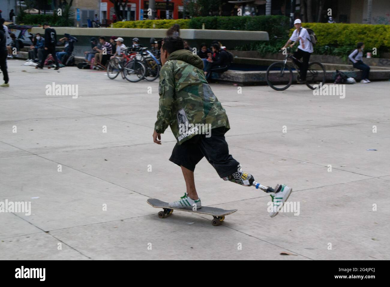 A skater with a prosthetic leg skates in the middle of World Skate Day