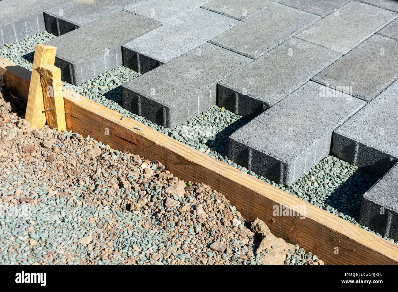 Gray stone pavers installation. Pavers installed in a running bond pattern on a gravel base next