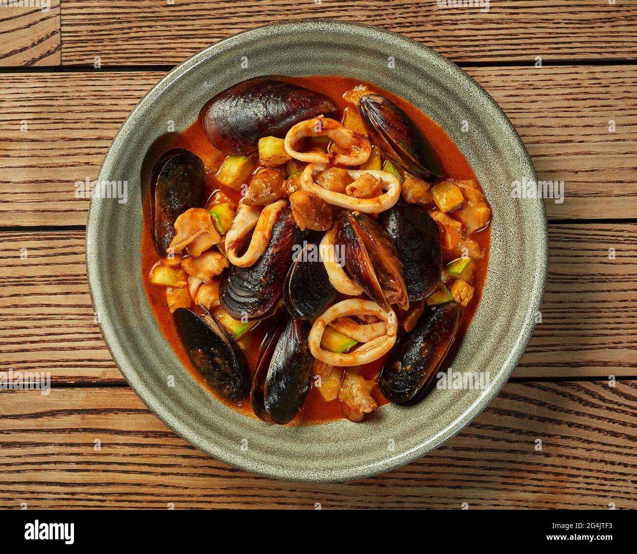 Seafood stew with fish, mussels, squid, whelks and vegetables Stock Photo Alamy