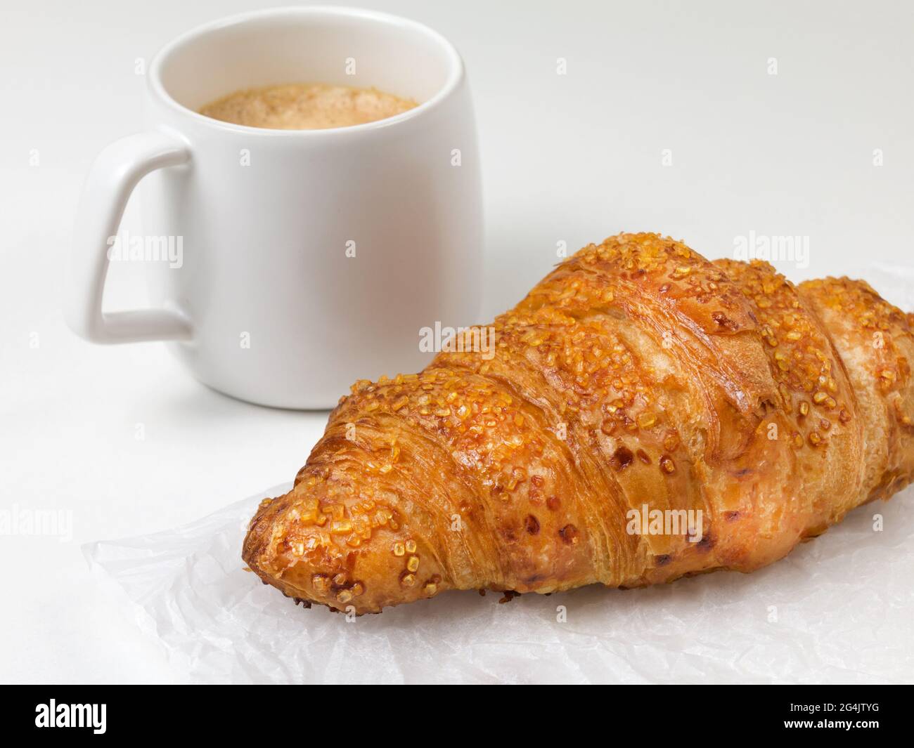 pastry croissant on white paper background with cup of coffee. French food Stock Photo