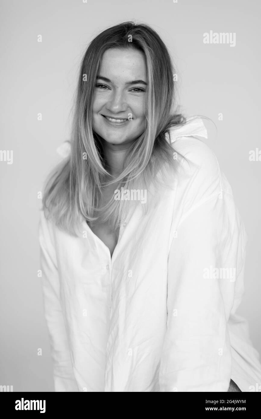 attractive fat woman in a white oversized shirt. Beautiful smiling woman Stock Photo