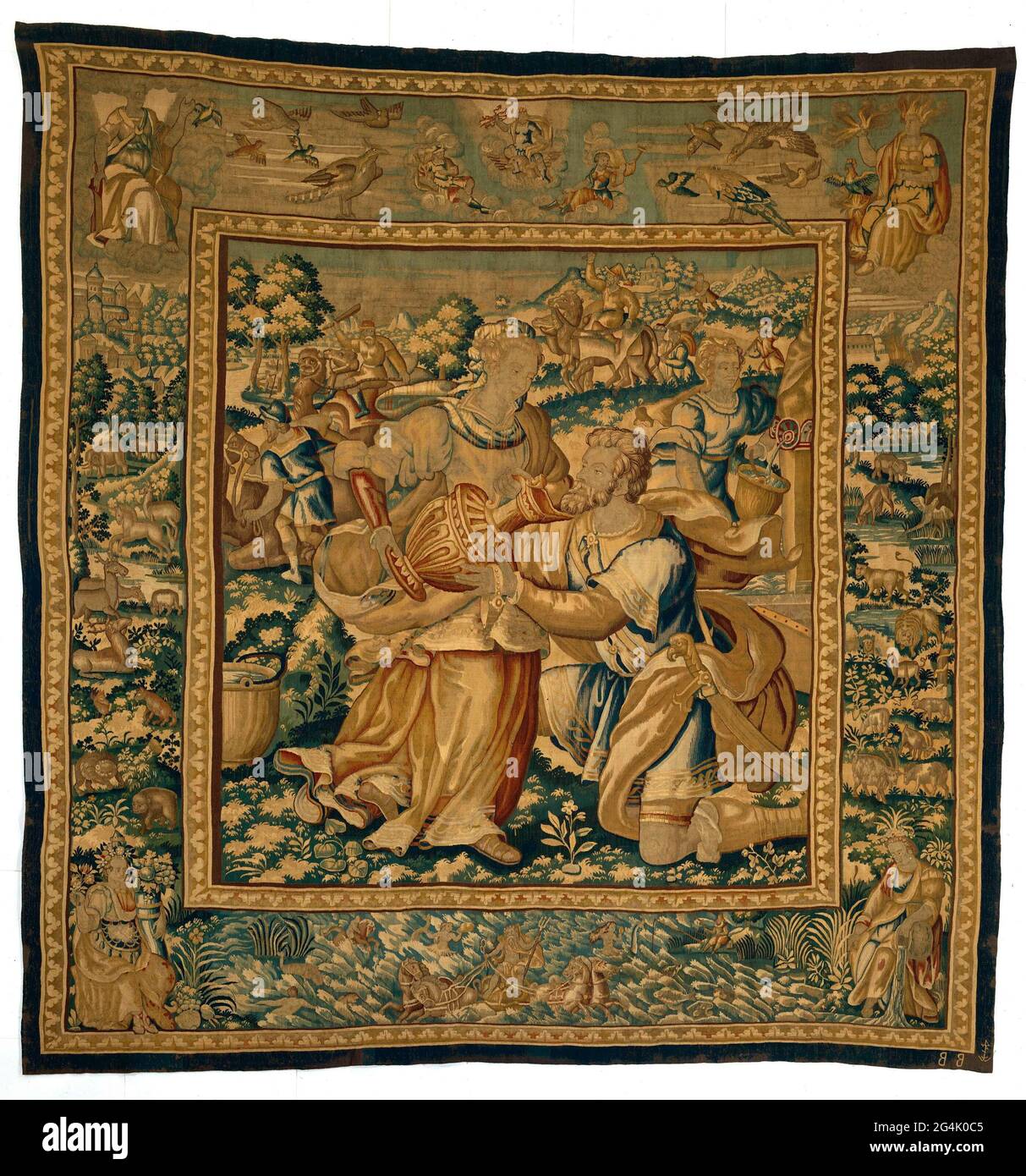 . Tapestry with Rebecca that gives eliezer to drink (Gen. 24:18), from a series of tapestries with the history of Rebecca and eliezer (GEN.24) with edges with animals and in the corners the four elements; With the weaver brand of Willem de Kempeneere. Stock Photo