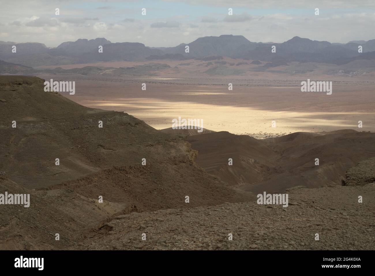 Arava Valley, in Jordan Valley, in Rift Valley & Edom Mts. seen from Ketura Heights in Eilat Mts., nice partly cloudy sky, patches of light & shadows. Stock Photo