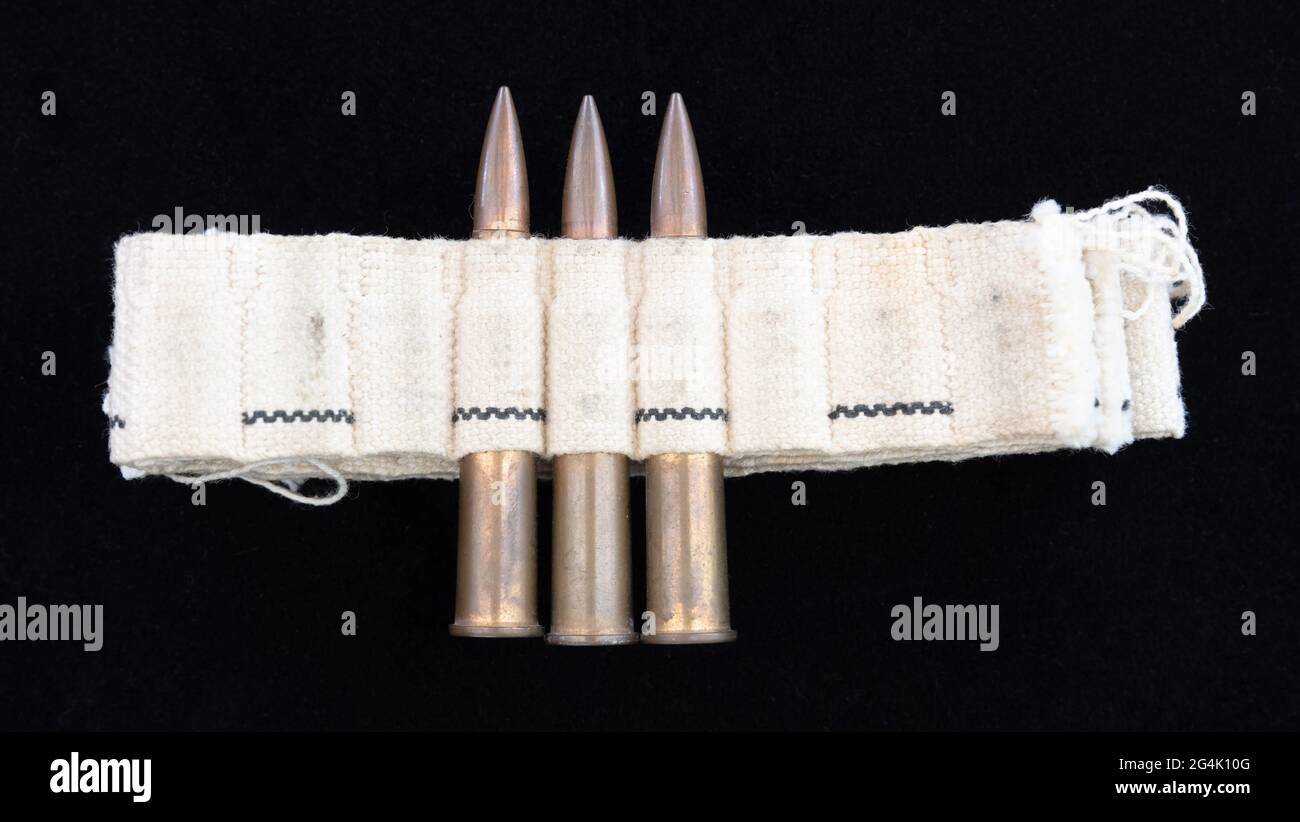 Machine gun ammo on a black background, unusual bullet belt Stock Photo