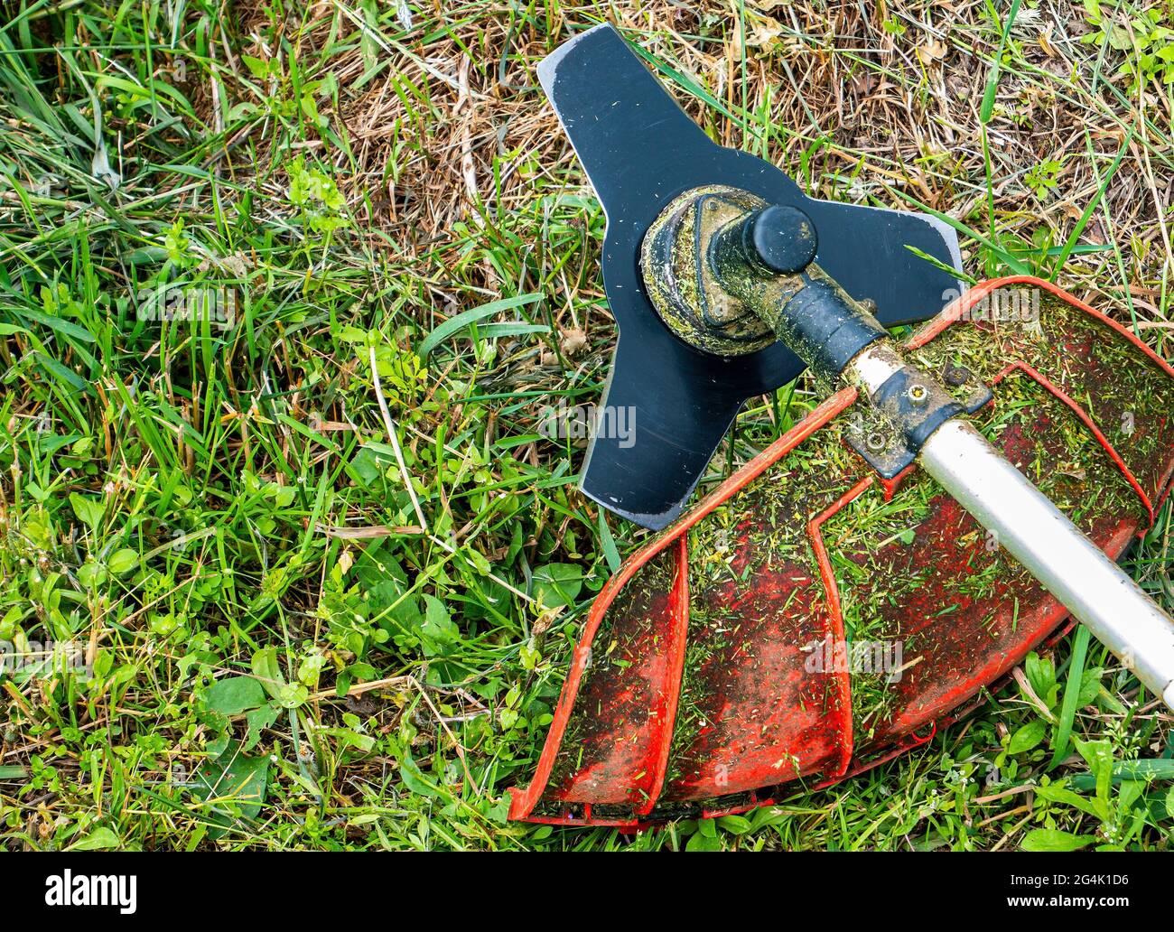 Lawn mower cutting disc for lawn mowing. Blade of knife. Trimmer cutting disc. Mow the grass with a lawn mower. Safety precautions. Garden equipment. Stock Photo